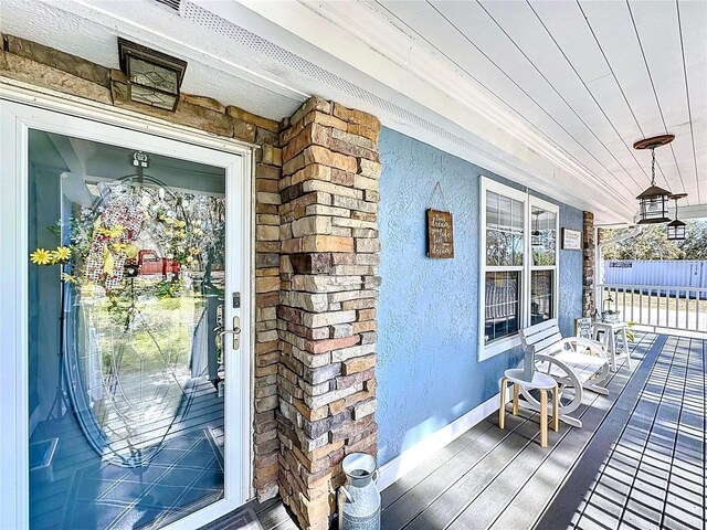 exterior space featuring a porch and stucco siding