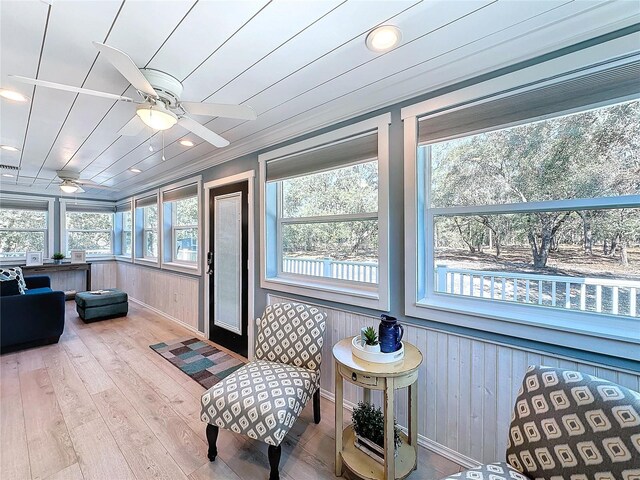 sunroom / solarium featuring ceiling fan