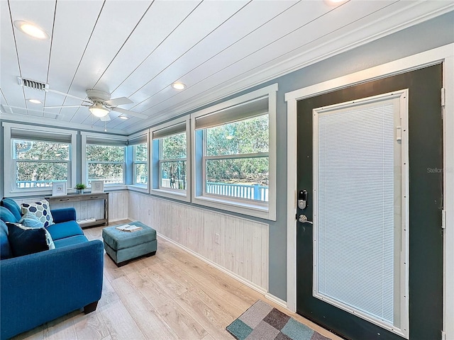 sunroom with ceiling fan and wooden ceiling