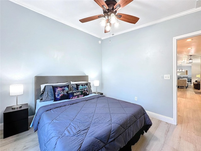 bedroom featuring ceiling fan, ornamental molding, and light hardwood / wood-style floors