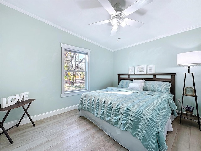 bedroom with baseboards, ornamental molding, a ceiling fan, and light wood-style floors