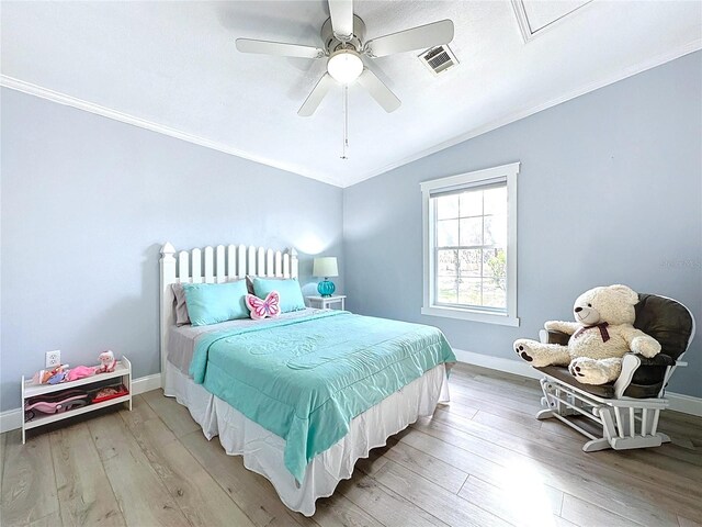 bedroom with hardwood / wood-style flooring, ornamental molding, and ceiling fan