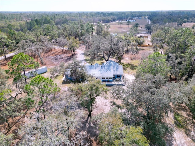 drone / aerial view featuring a wooded view and a rural view