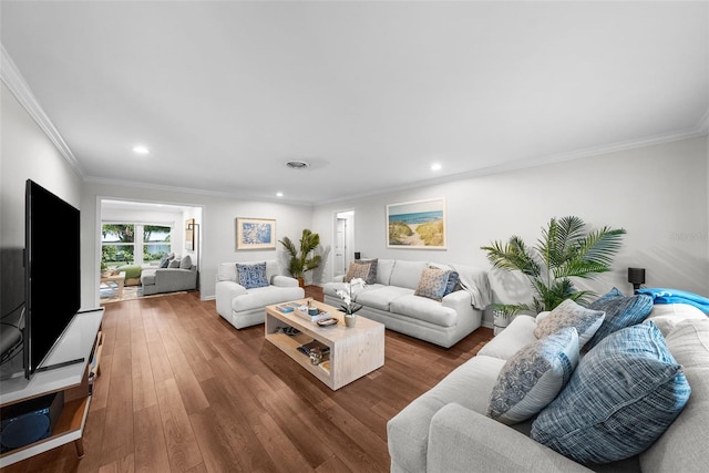 living room featuring crown molding and hardwood / wood-style floors