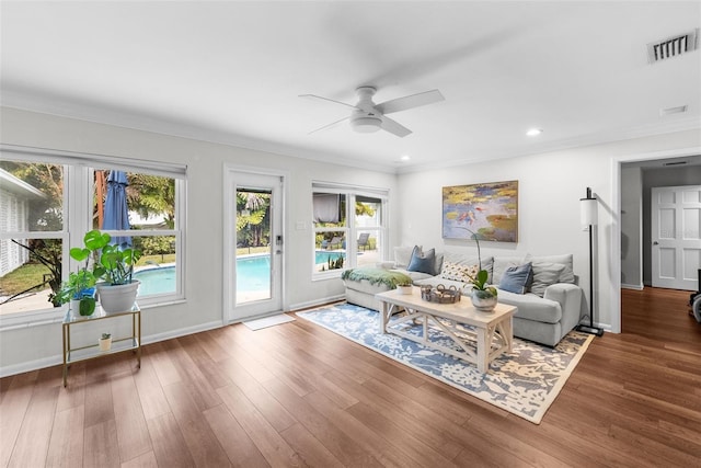 living room featuring crown molding, dark hardwood / wood-style floors, and ceiling fan