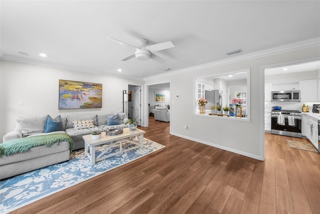 living room featuring crown molding, ceiling fan, and wood-type flooring