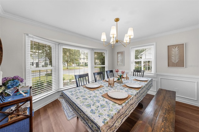 dining room with an inviting chandelier, crown molding, and dark hardwood / wood-style flooring