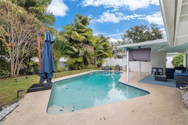 view of swimming pool featuring a patio, outdoor lounge area, ceiling fan, and a lawn