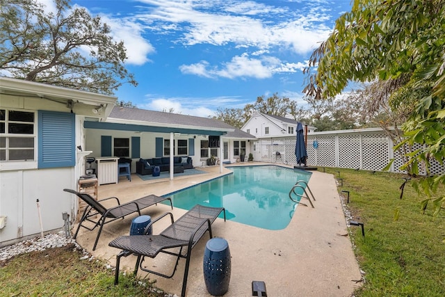 view of pool with a yard, outdoor lounge area, and a patio