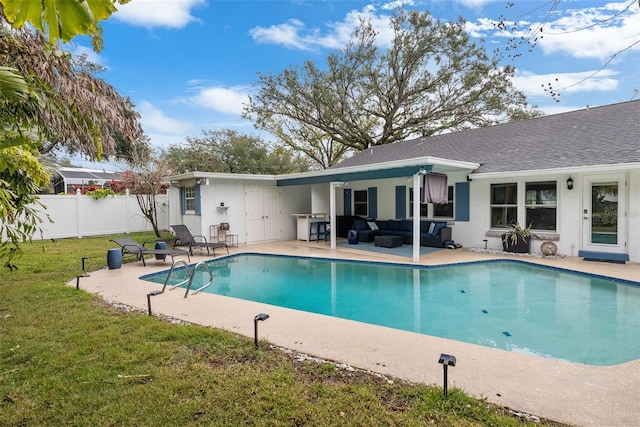 view of swimming pool with a yard, outdoor lounge area, and a patio