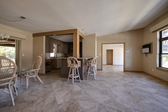 interior space featuring lofted ceiling, sink, and heating unit