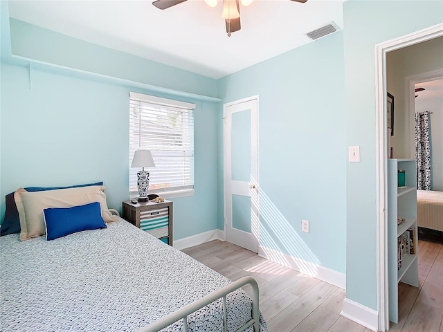 bedroom with ceiling fan and light wood-type flooring