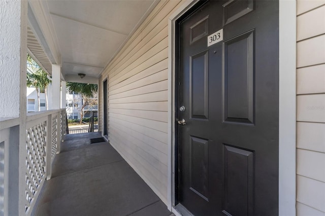 view of exterior entry with covered porch