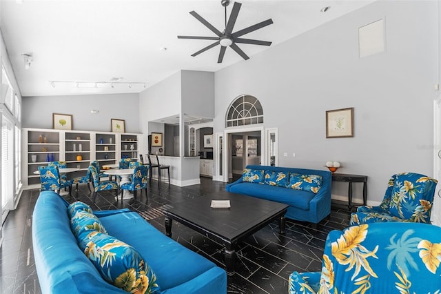 living room with vaulted ceiling, track lighting, and ceiling fan