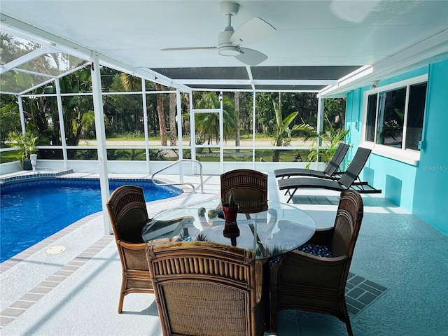 view of pool with ceiling fan, a patio, and glass enclosure