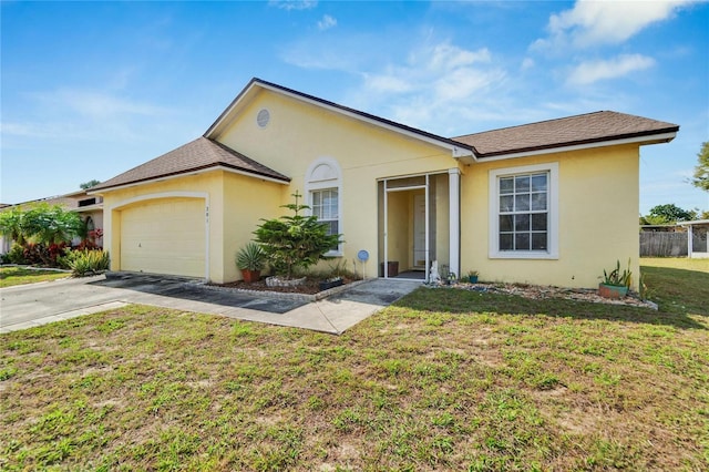 ranch-style house featuring a garage and a front yard