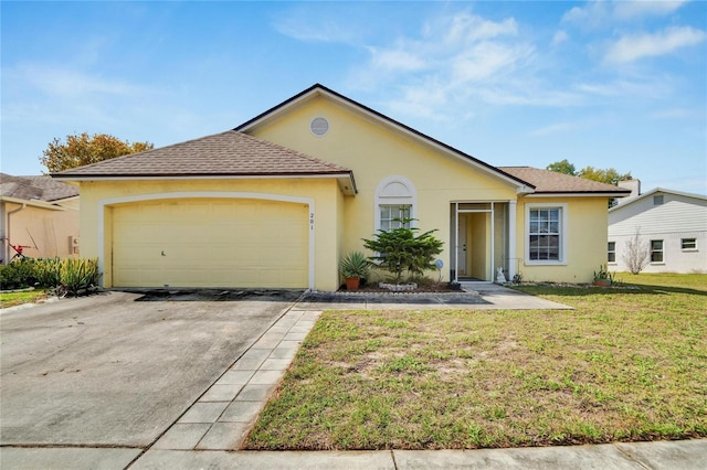 view of front of property featuring a garage and a front yard