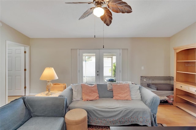 living room with french doors, ceiling fan, and light hardwood / wood-style floors