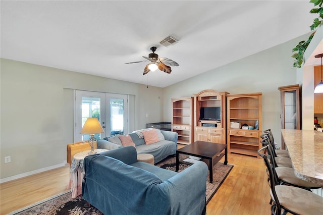 living room featuring french doors, ceiling fan, and light hardwood / wood-style flooring