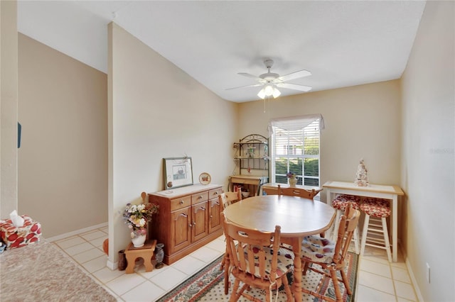 dining space featuring light tile patterned floors and ceiling fan