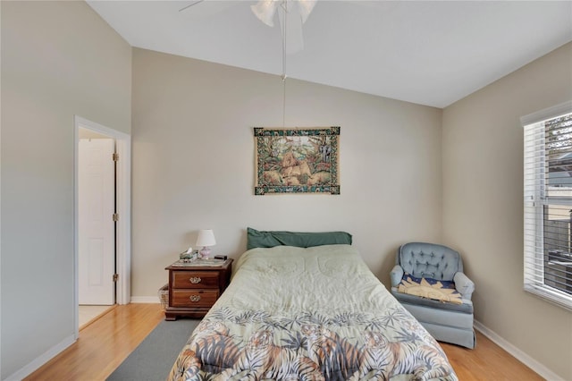 bedroom with vaulted ceiling, light wood-type flooring, and ceiling fan