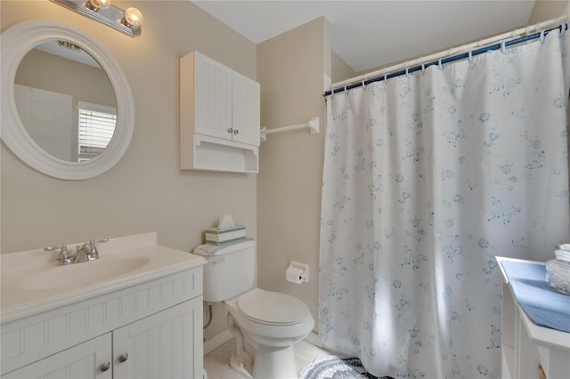 bathroom with vanity, curtained shower, tile patterned floors, and toilet