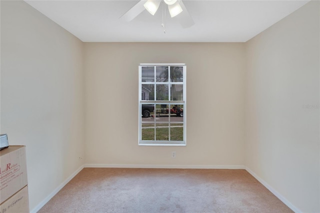 empty room with light colored carpet and ceiling fan