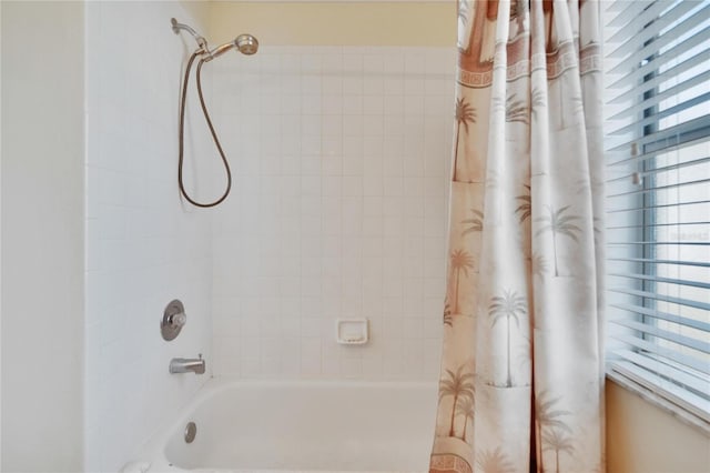 bathroom with shower / bathtub combination with curtain