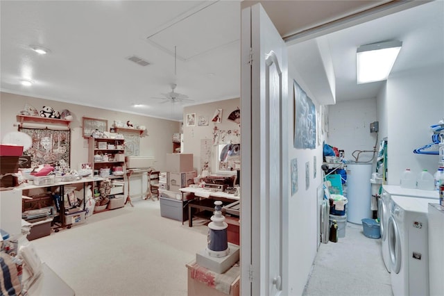 laundry area with gas water heater, washer and dryer, light carpet, and a workshop area