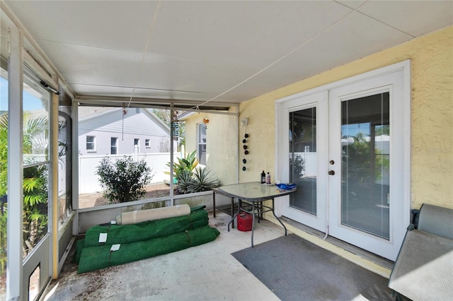 sunroom / solarium with a healthy amount of sunlight and french doors