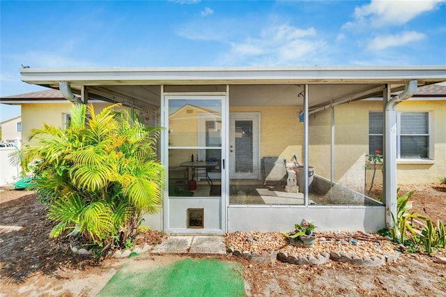 back of house with a sunroom