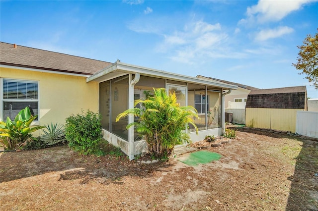 view of property exterior with a sunroom and central AC unit