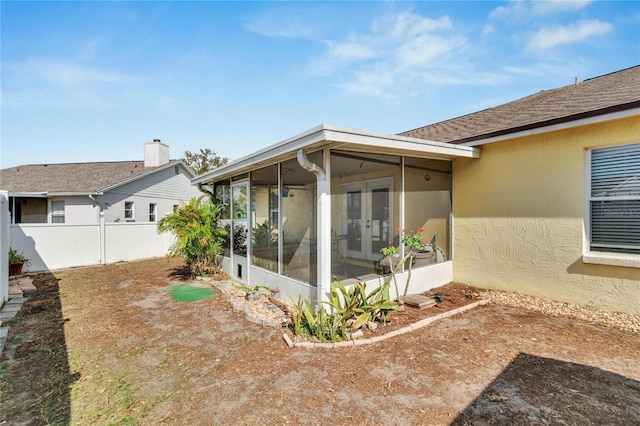 rear view of property with french doors and a sunroom