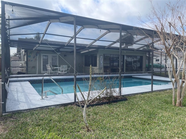 view of pool featuring a lanai, a lawn, and a patio