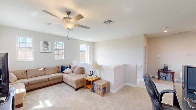 living room featuring light carpet and ceiling fan