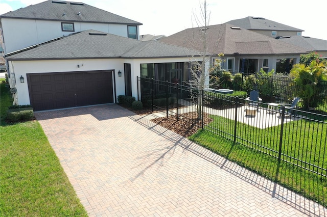 view of front of property with a garage and a front yard