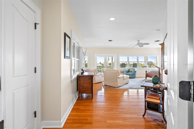 hall with light hardwood / wood-style floors and french doors