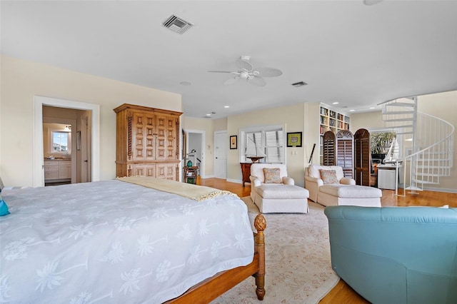 bedroom featuring multiple windows, ceiling fan, and light wood-type flooring