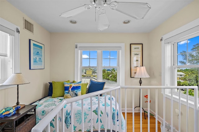 bedroom with hardwood / wood-style flooring and ceiling fan