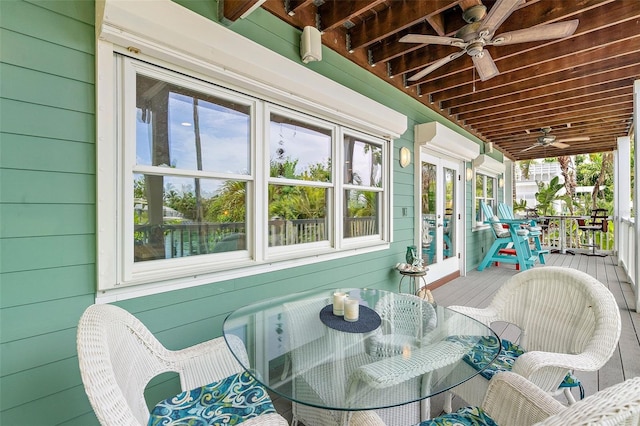 sunroom / solarium featuring wood ceiling, ceiling fan, a healthy amount of sunlight, and an AC wall unit