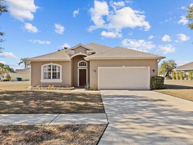 view of front of house featuring a garage and a front lawn