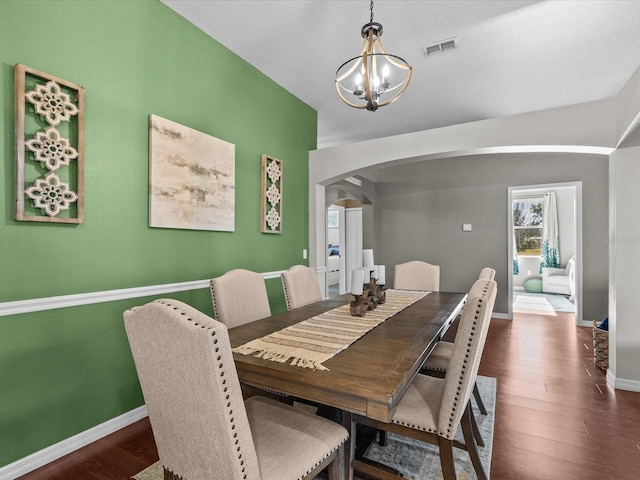 dining area featuring dark hardwood / wood-style floors and a notable chandelier