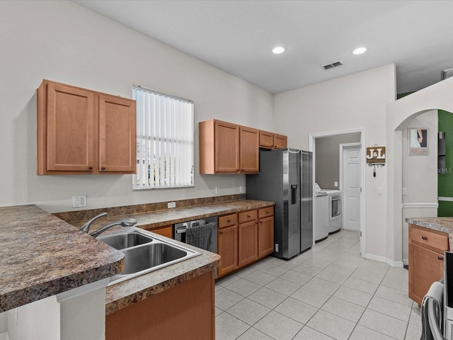 kitchen with stainless steel appliances, light tile patterned flooring, sink, and kitchen peninsula