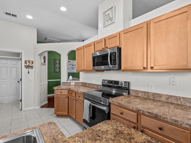 kitchen featuring stainless steel appliances, sink, and light tile patterned floors