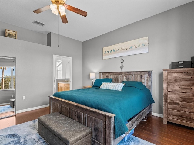 bedroom with ceiling fan, dark hardwood / wood-style floors, and ensuite bath