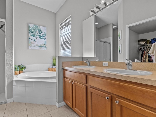 bathroom with tile patterned flooring, vanity, and separate shower and tub