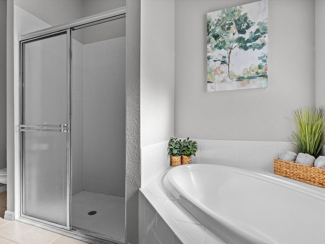 bathroom with separate shower and tub, tile patterned floors, and toilet