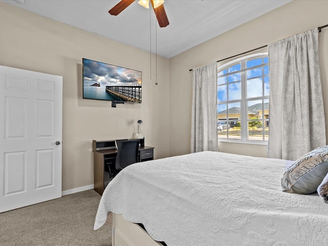 bedroom featuring ceiling fan and carpet