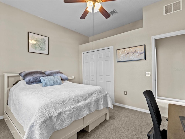 carpeted bedroom with ceiling fan and a closet