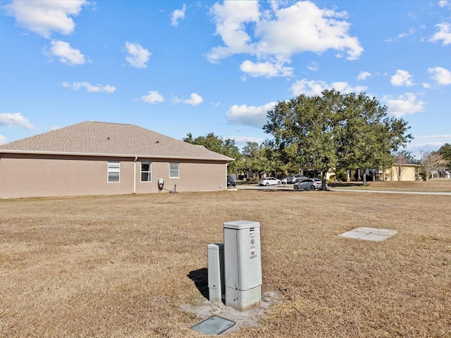 back of house with a lawn